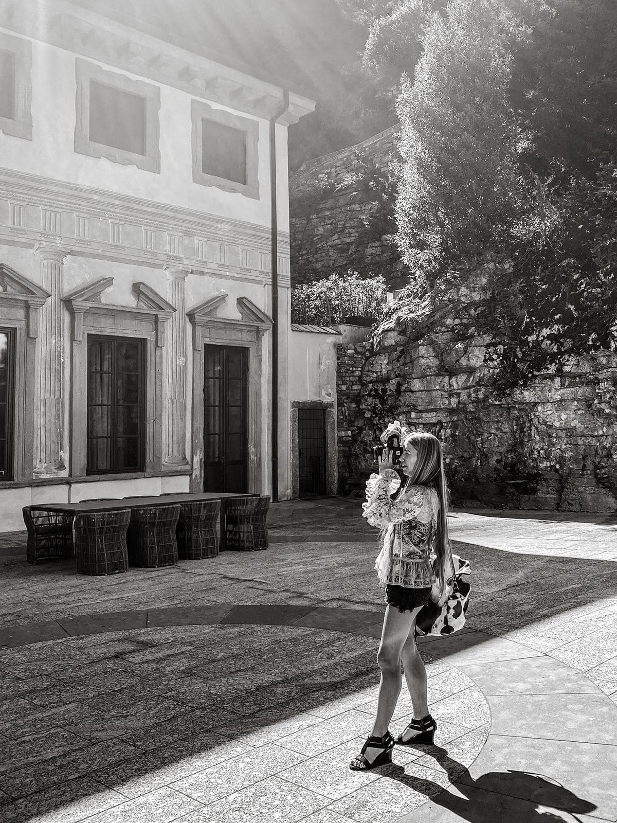 Woman takes photos of exterior of Villa Pliniana