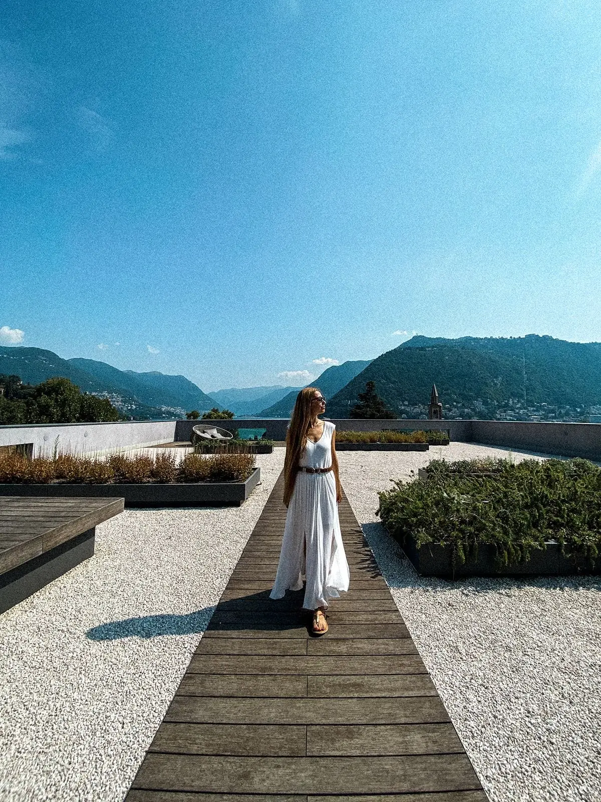 Woman walks on the grounds outside Hilton Lake Como