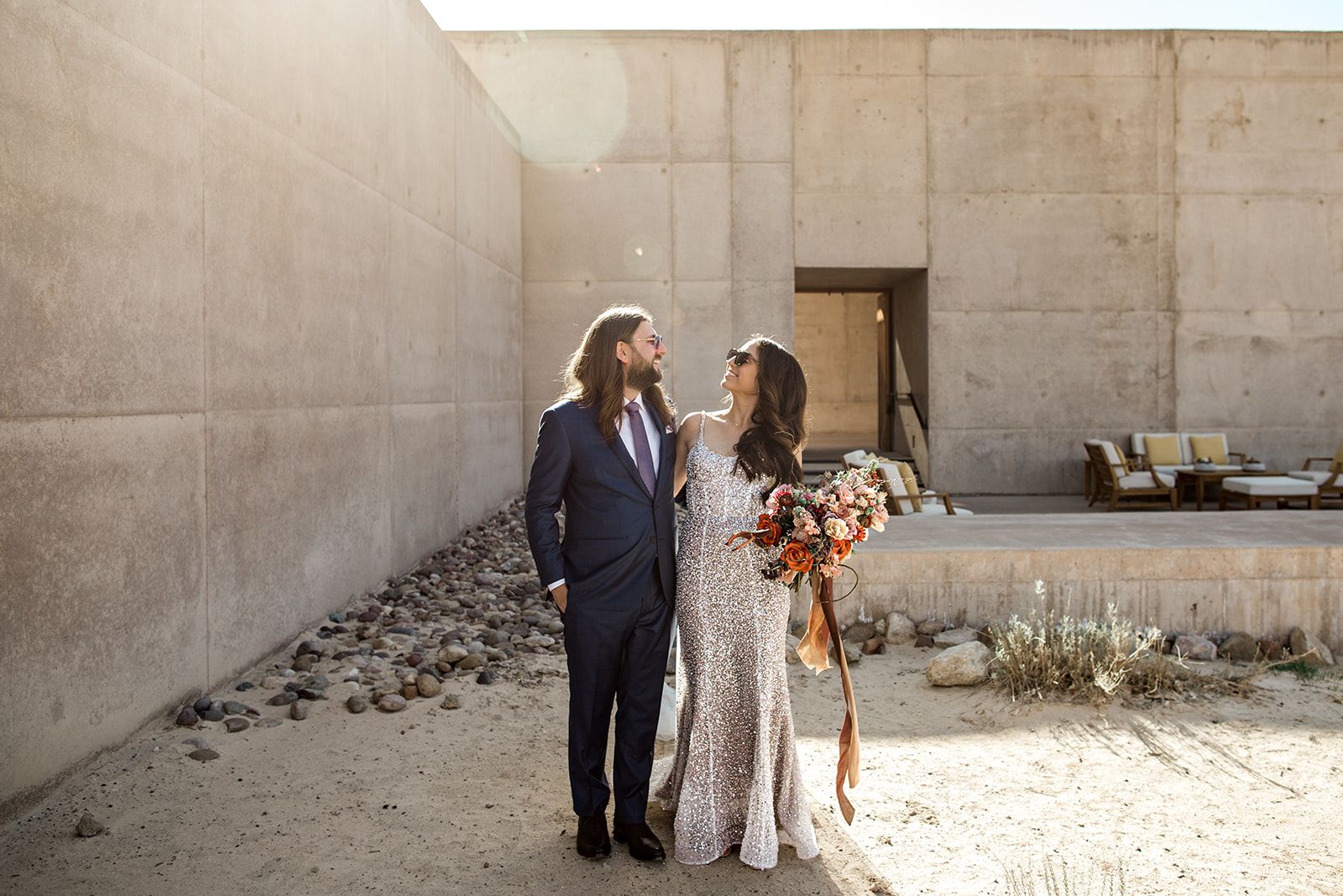 Bride and groom pose for portrait at Amangiri