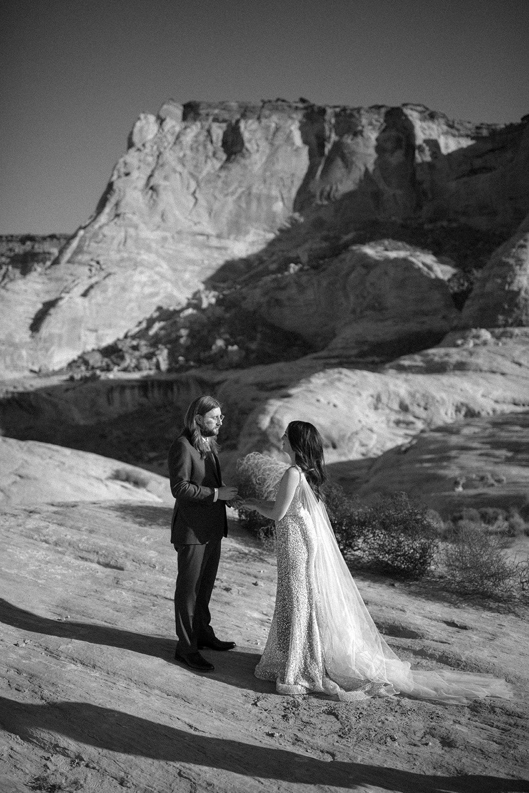 Bride and groom stand at ceremony site for their elopement in Amangiri Utah