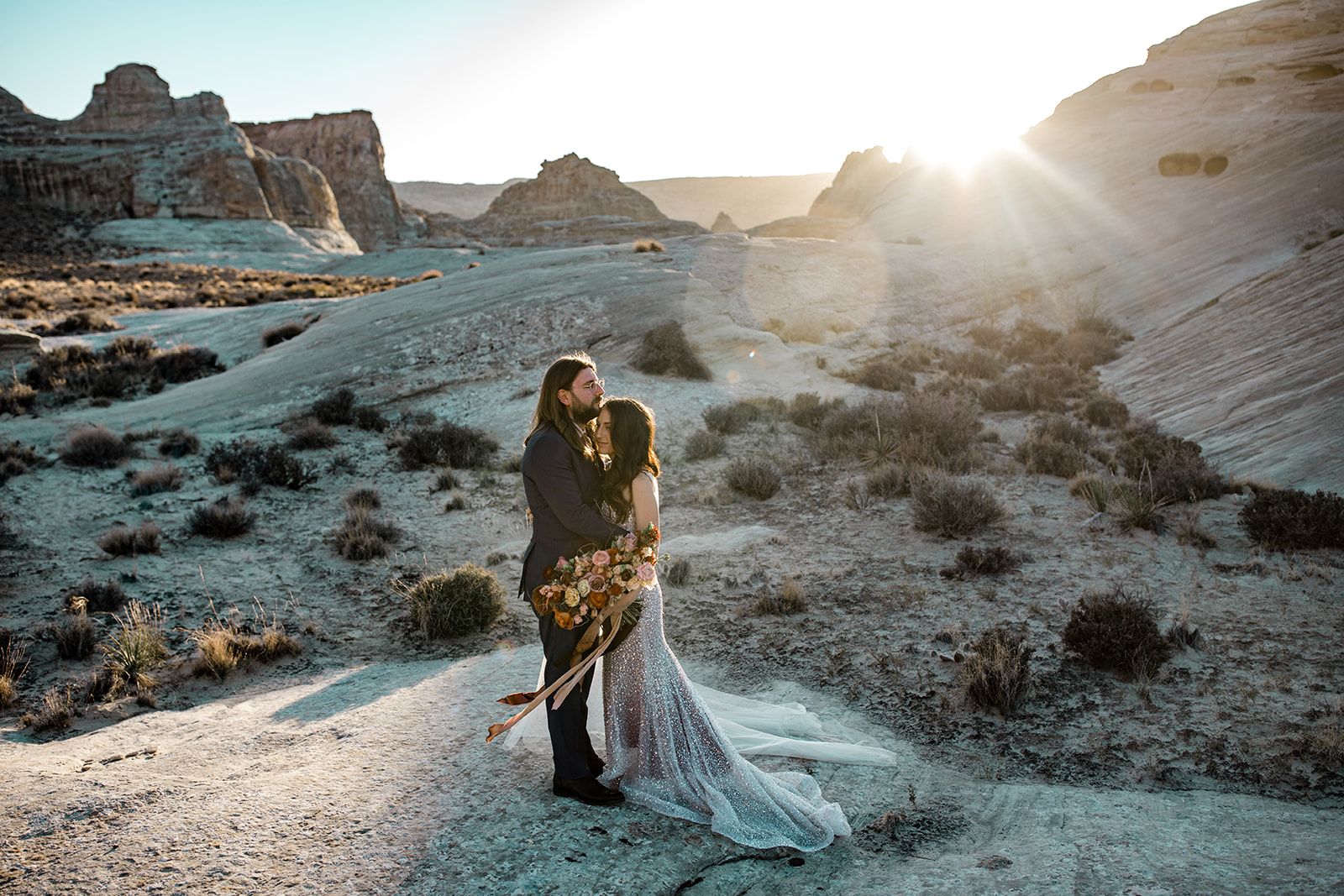 Bride and groom embrace in Utah desert