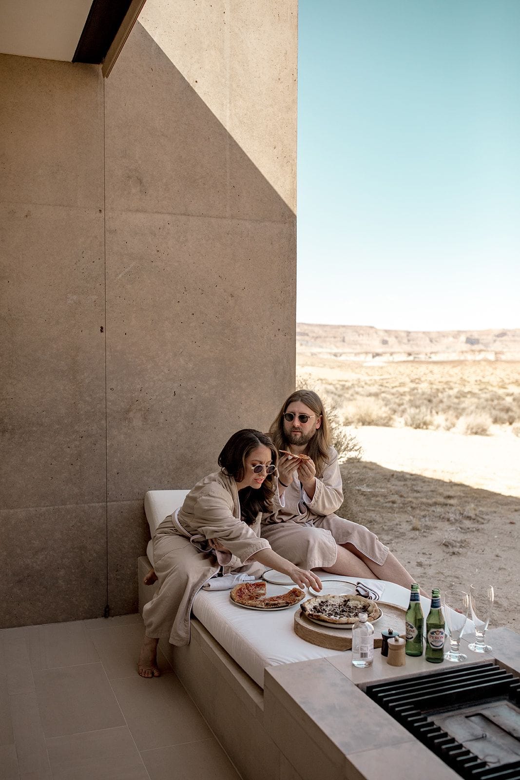 Bride and groom share a pizza party before elopement ceremony at Amangiri