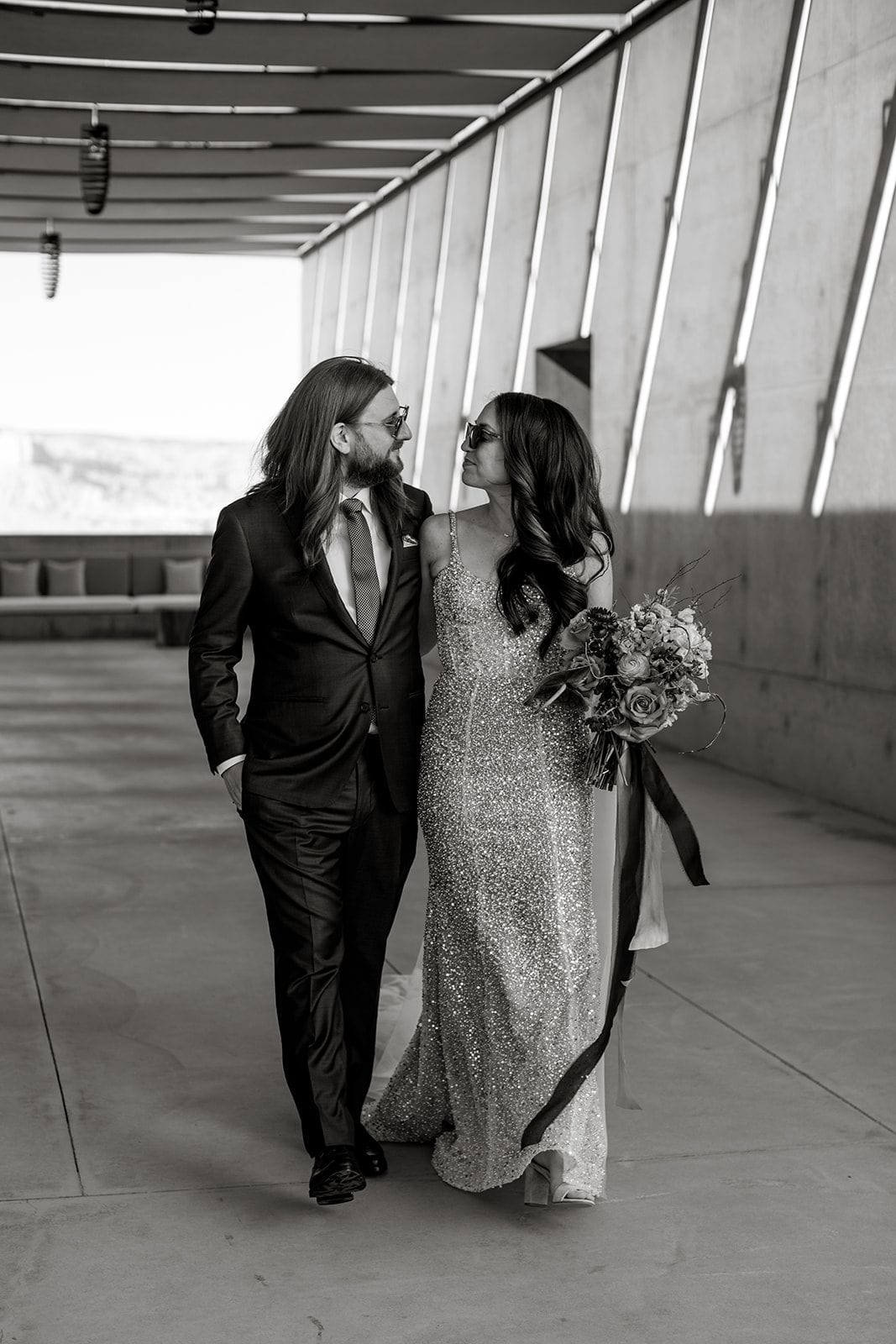 Bride and groom walk through Amangiri Utah