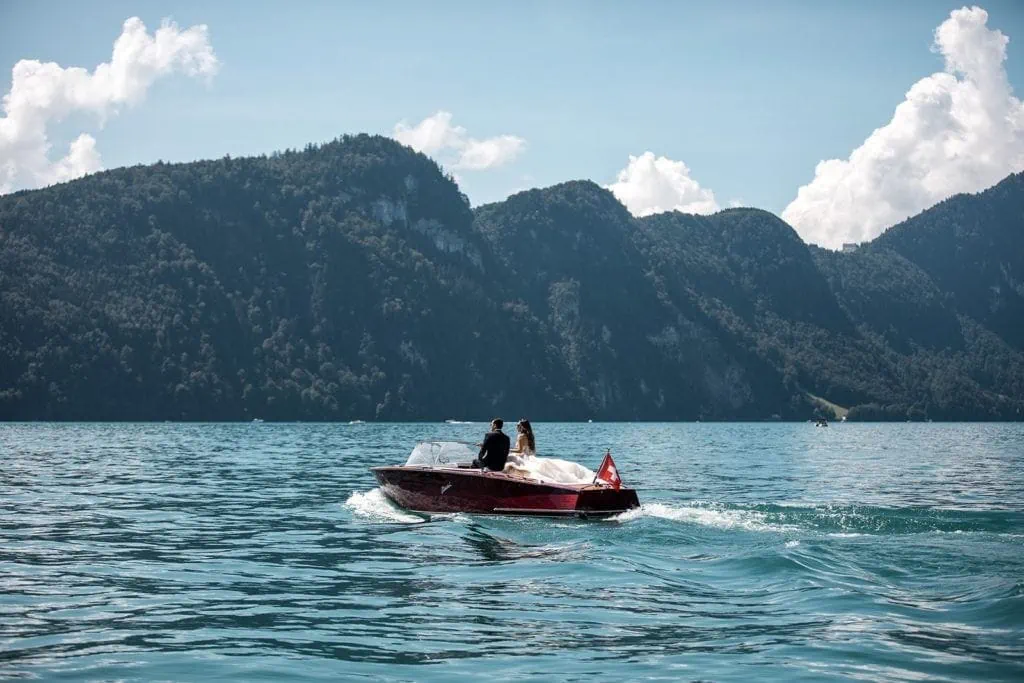 Bride and groom take a romantic boat ride across Lake Lucerne before wedding ceremony