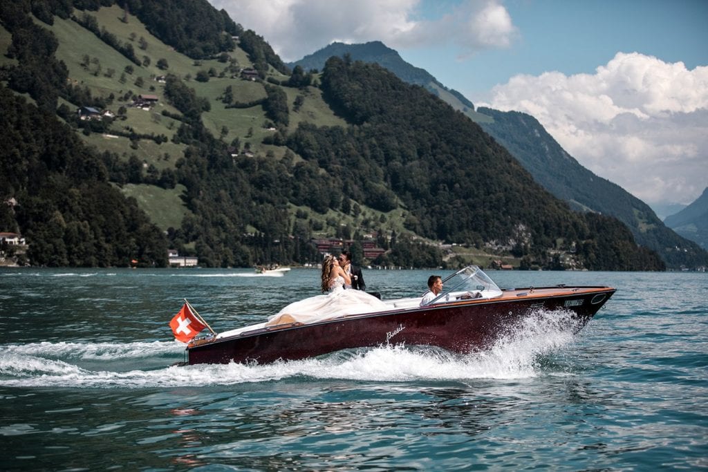 Groom and bride take a boat ride before their Lake Lucerne wedding in Switzerland