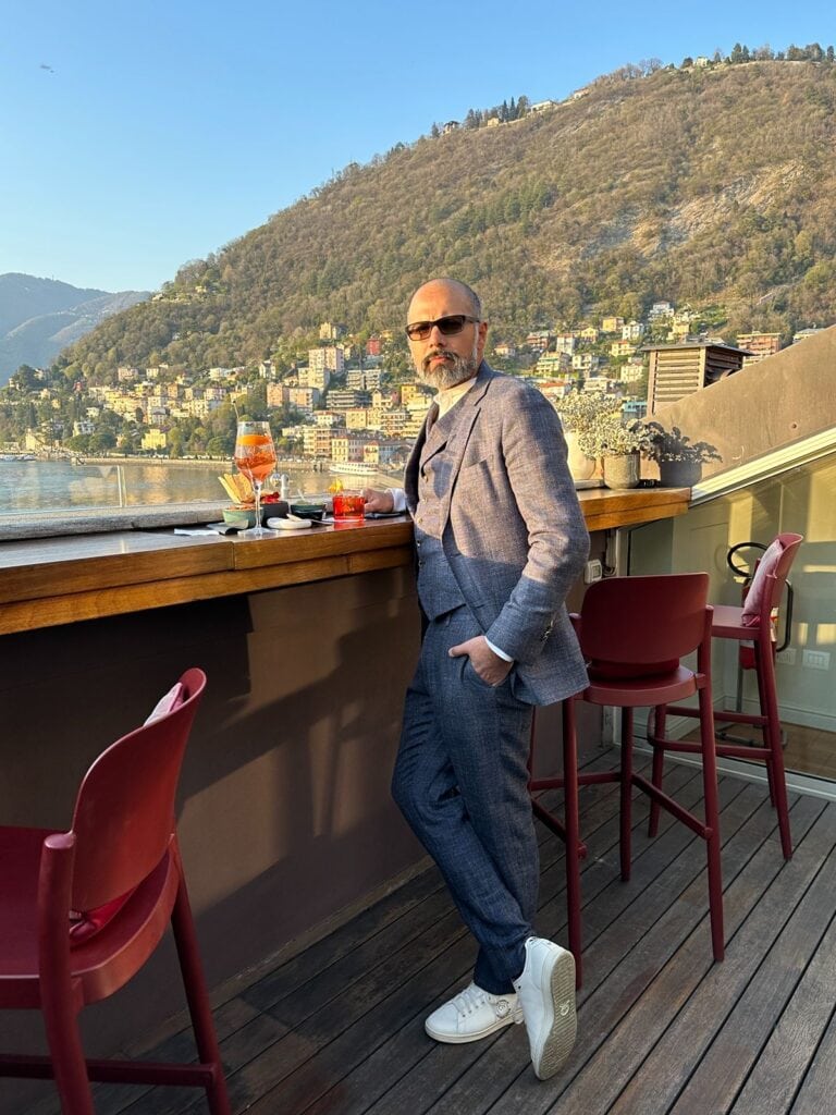 Vic from Lilly Red Photography enjoying aperitif overlooking Lake Como at Sotovocce Restaurant