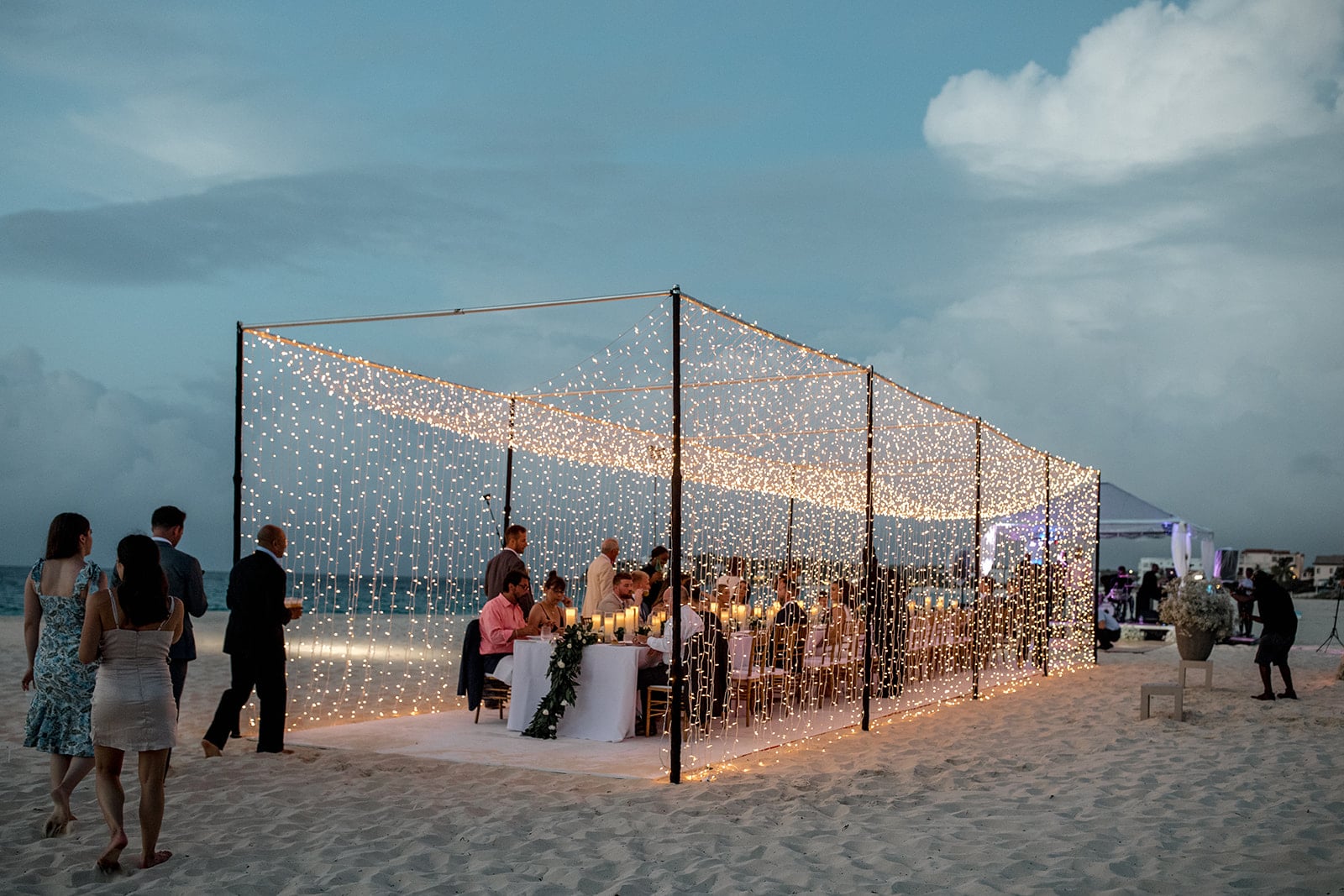 Anguilla destination wedding reception with a tunnel of lights and banquet style table
