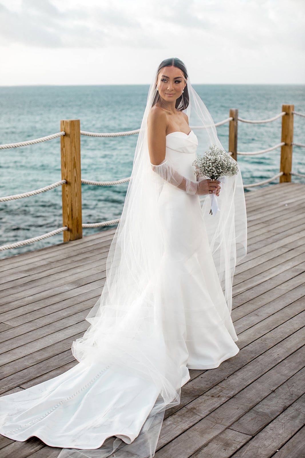 Bride holds bouquet on Anguilla beach