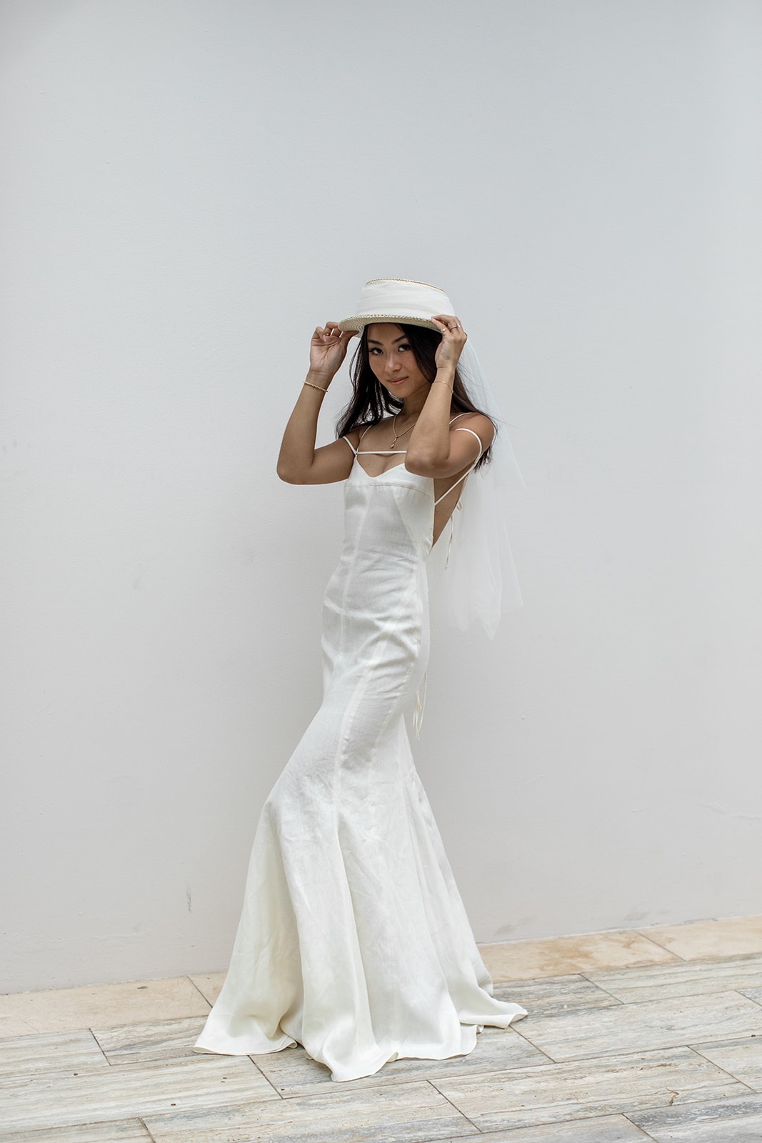 Editorial bridal portrait wearing a simple, elegant gown