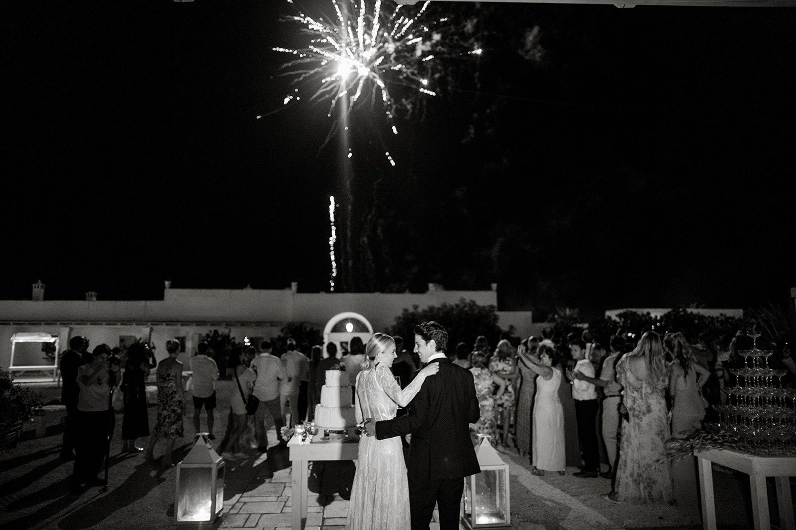 Bride and groom watch Apulian fireworks at wedding reception