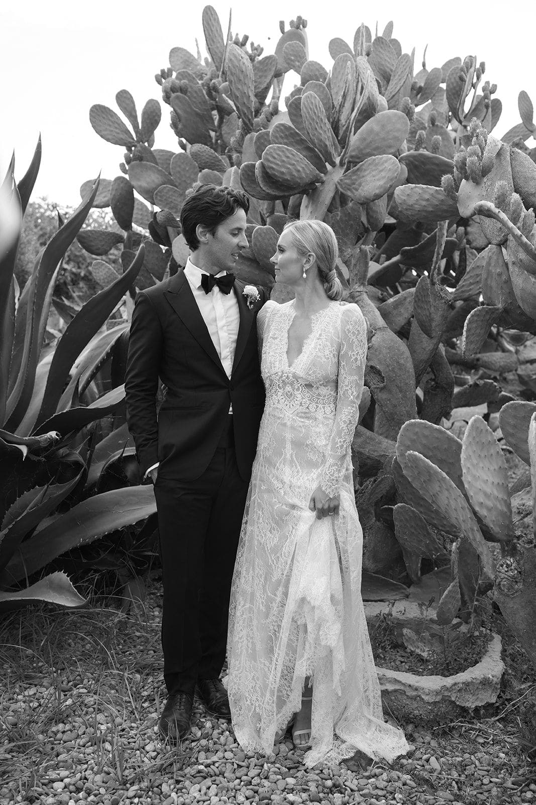 Bride and groom black and white portrait among cactus in Puglia Italy destination wedding