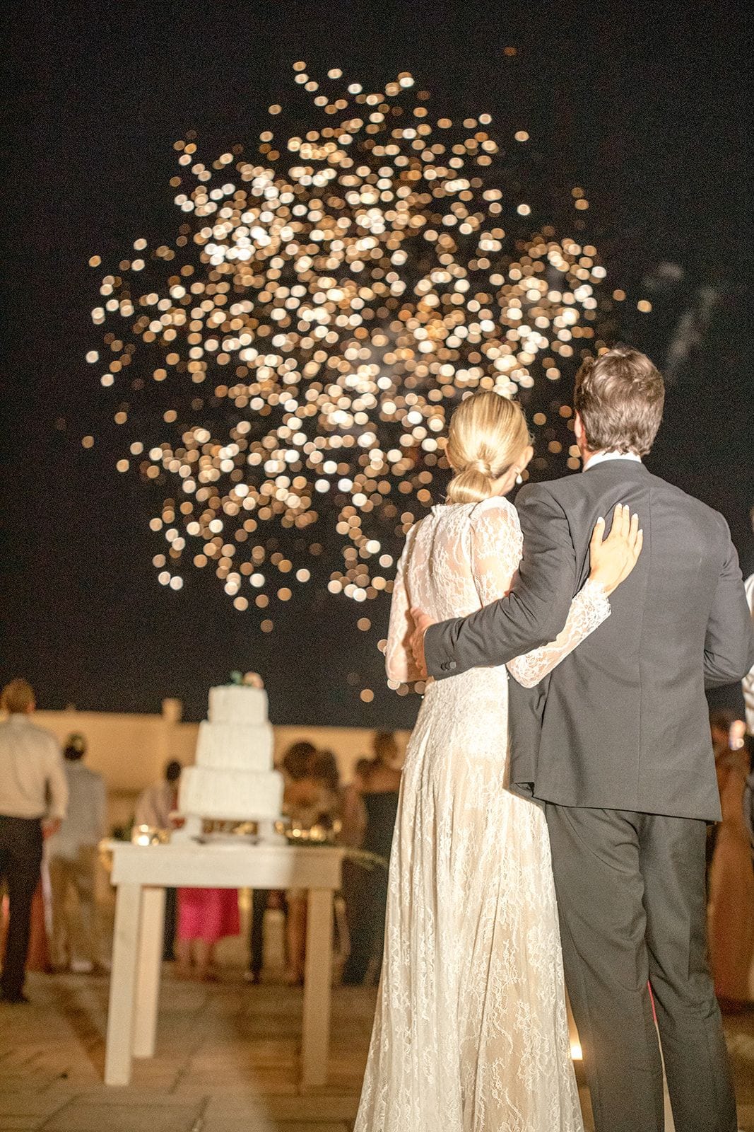 Bride and groom watch fireworks at Masseria Potenti reception