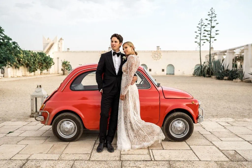 Bride groom with red small red car Masseria Potenti