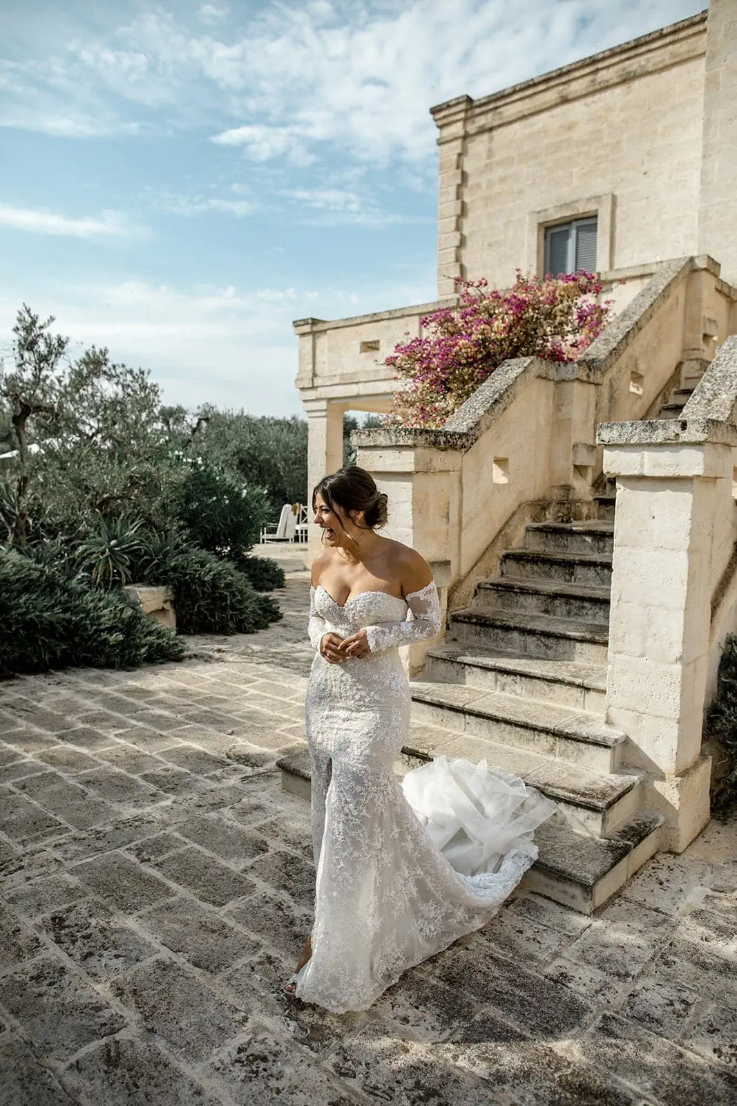 Bride walks down stairs at Borgo Egnazia wedding