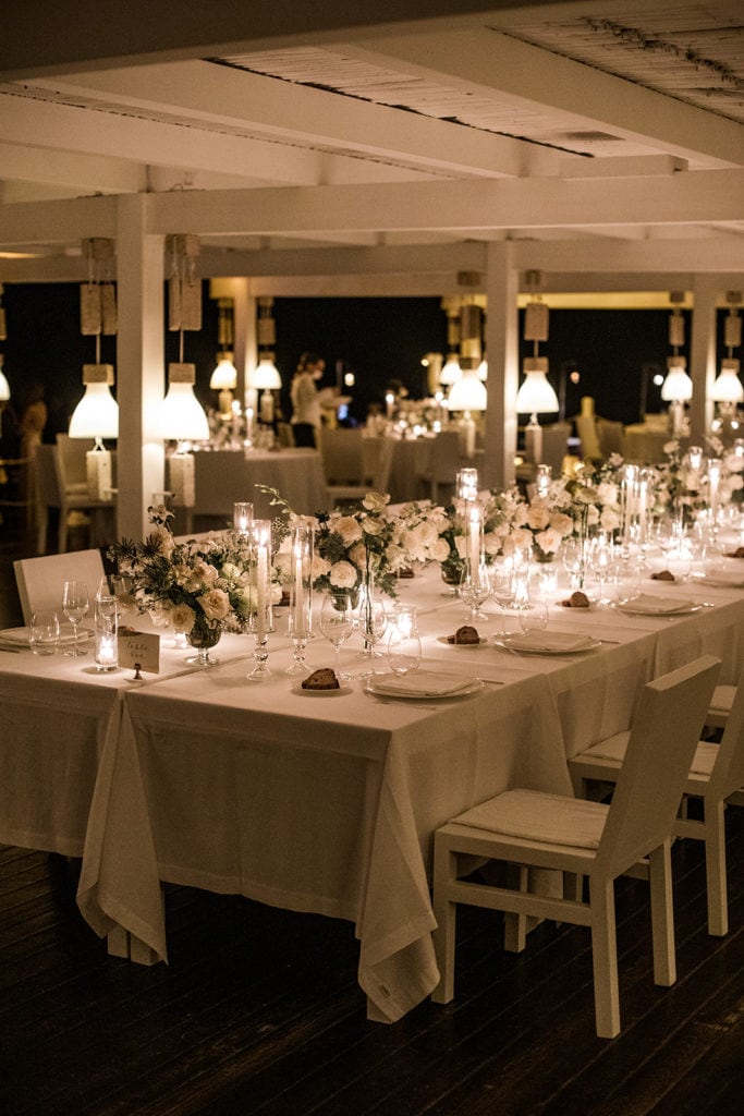 An elegant wedding reception tablescape at the Cala Masciola Beach Club in Puglia, Italy. 