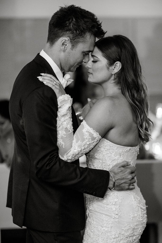 A bride and groom share their first dance together as a newly married couple. 