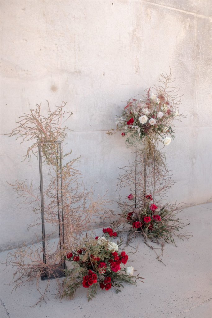 Small, delicate flowers combined with clusters of red roses create the color story of a Utah wedding.