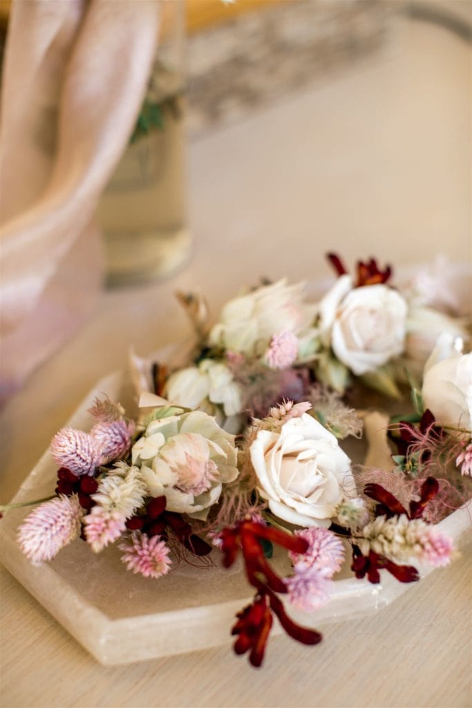 Pink, white, and red small flowers create the boutonnieres for an Amangiri wedding. 