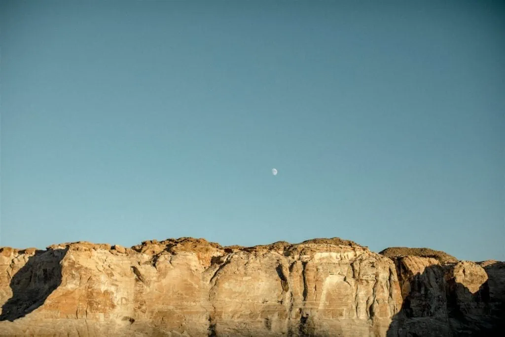 The moon rises over the plateaus in Canyon Point, Utah. 