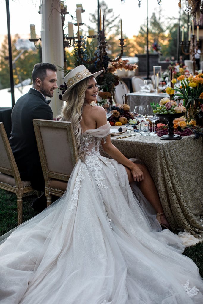 A bride and groom sit together at their sweetheart table during their Napa Valley wedding reception. 