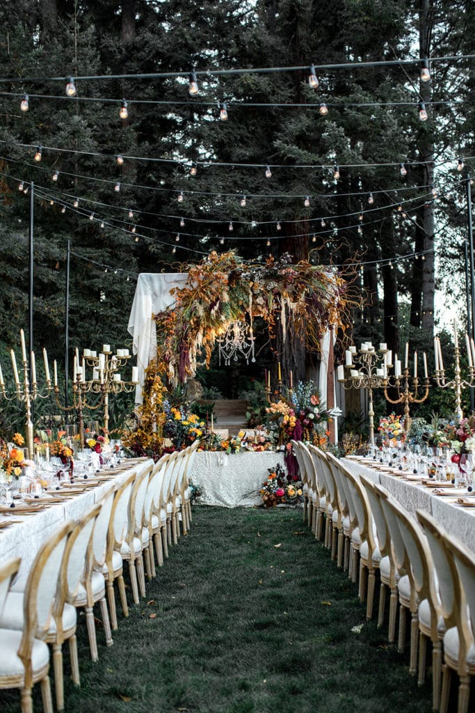 Banquet tables lead directly to an irresistible sweetheart table at a Calistoga Vineyard Estate wedding reception. 