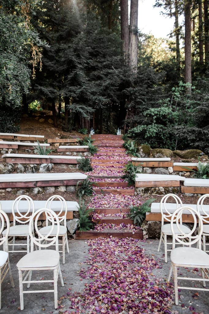 Pink flower petals create a bridal carpet at the Calistoga Vineyard Estate wedding ceremony. 