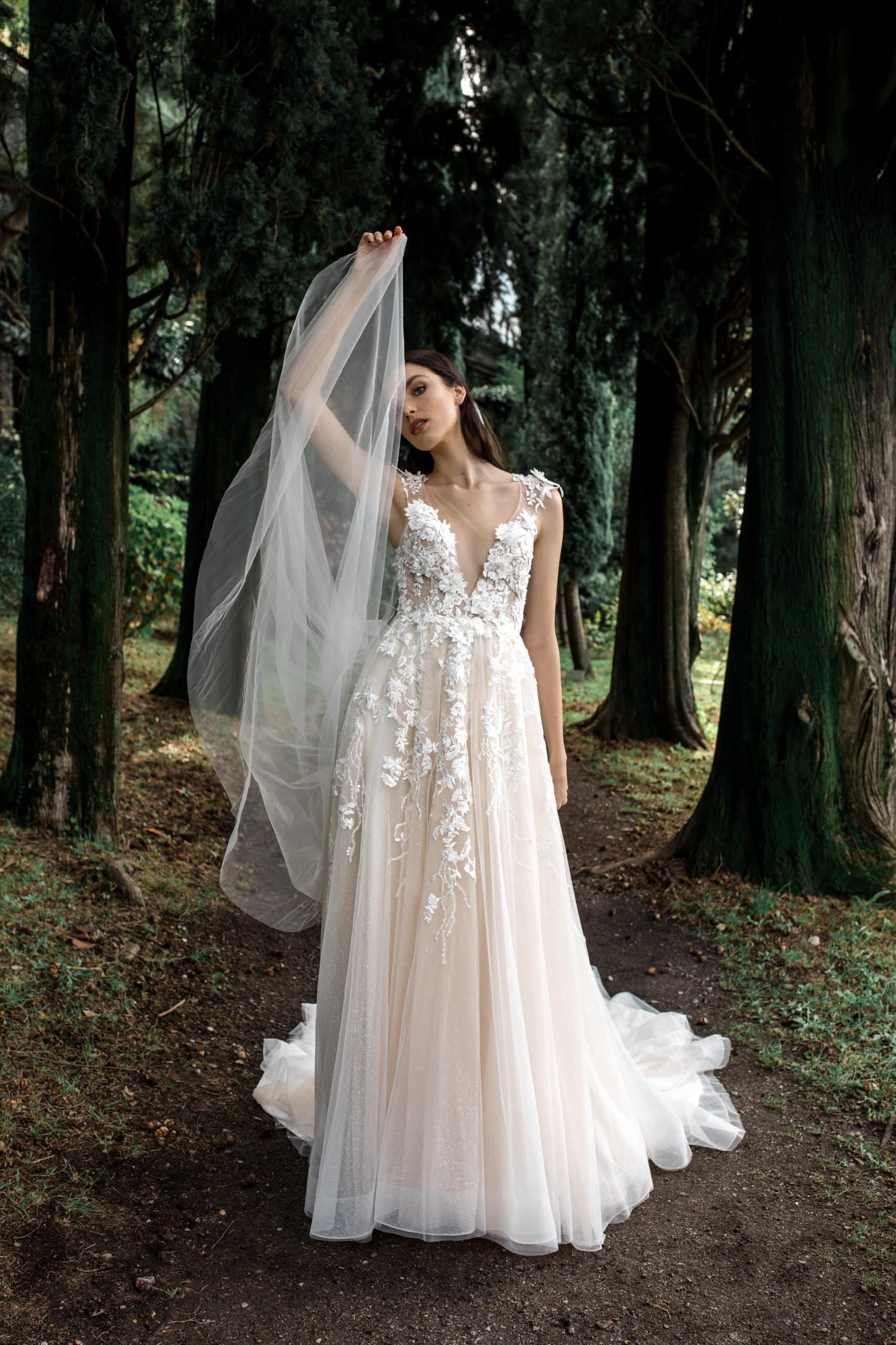 Lace floral bridal gown modeled in Lake Como