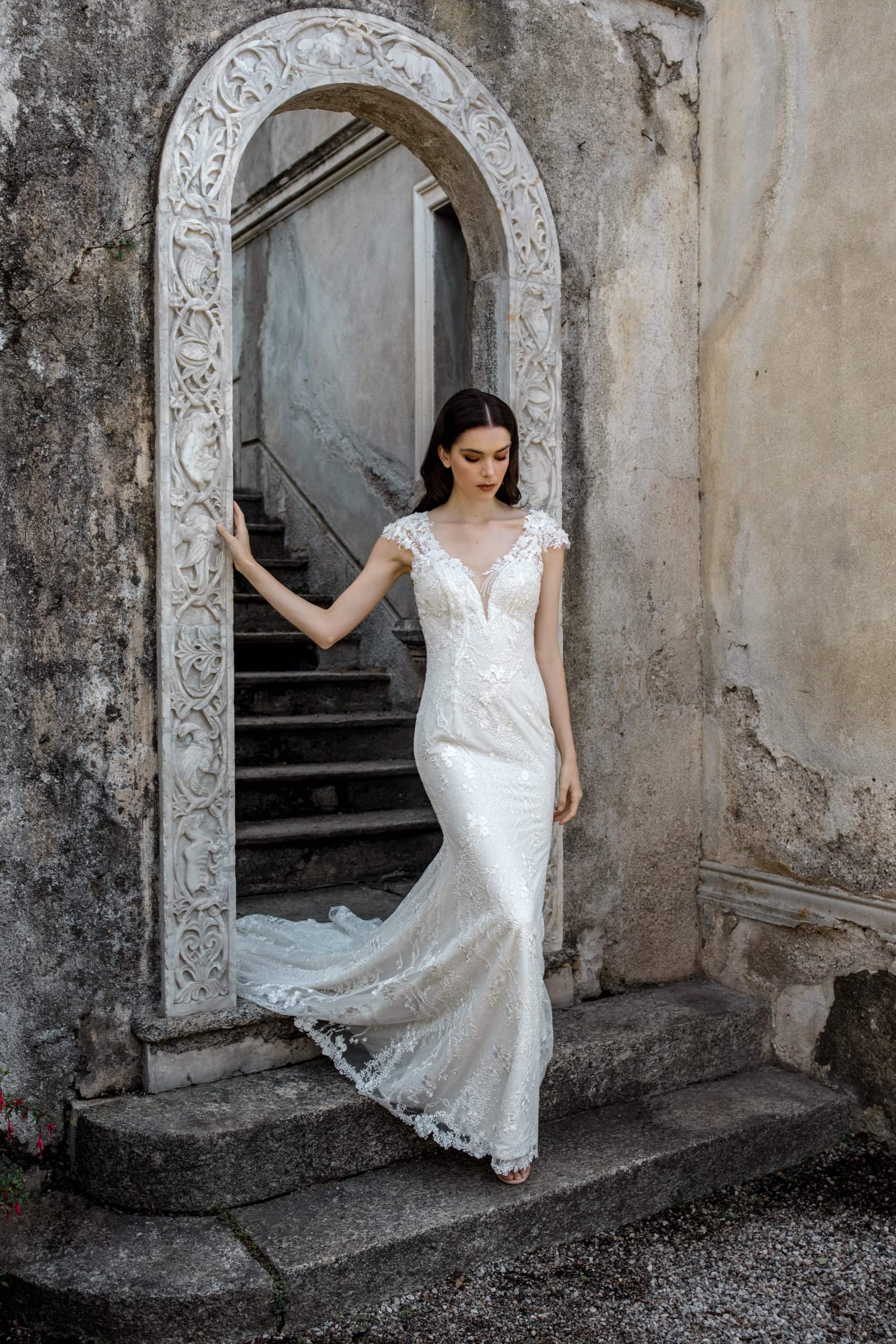 Model steps out of Villa Monastero in lace wedding dress
