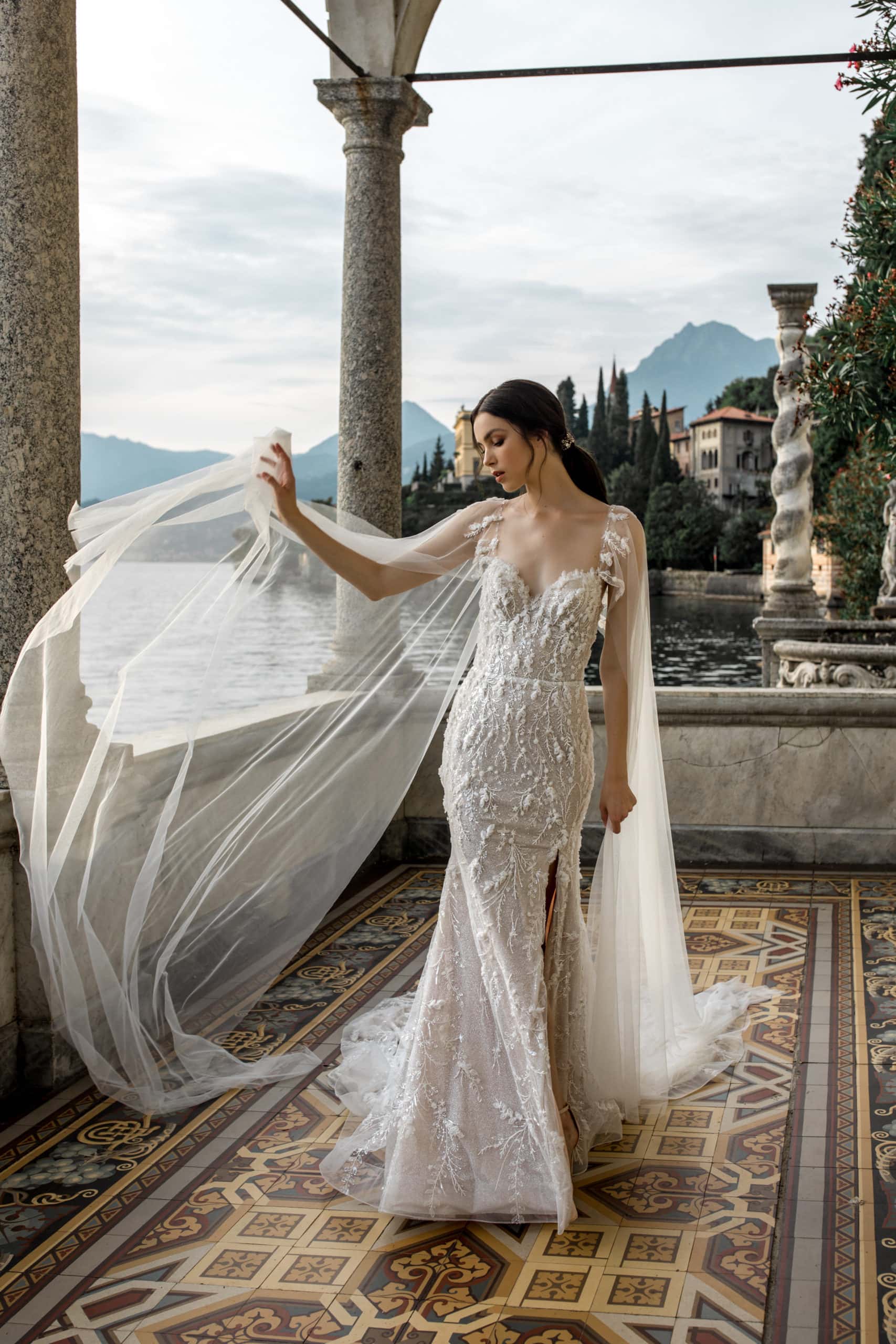 Model tosses veil in detailed mermaid style dress