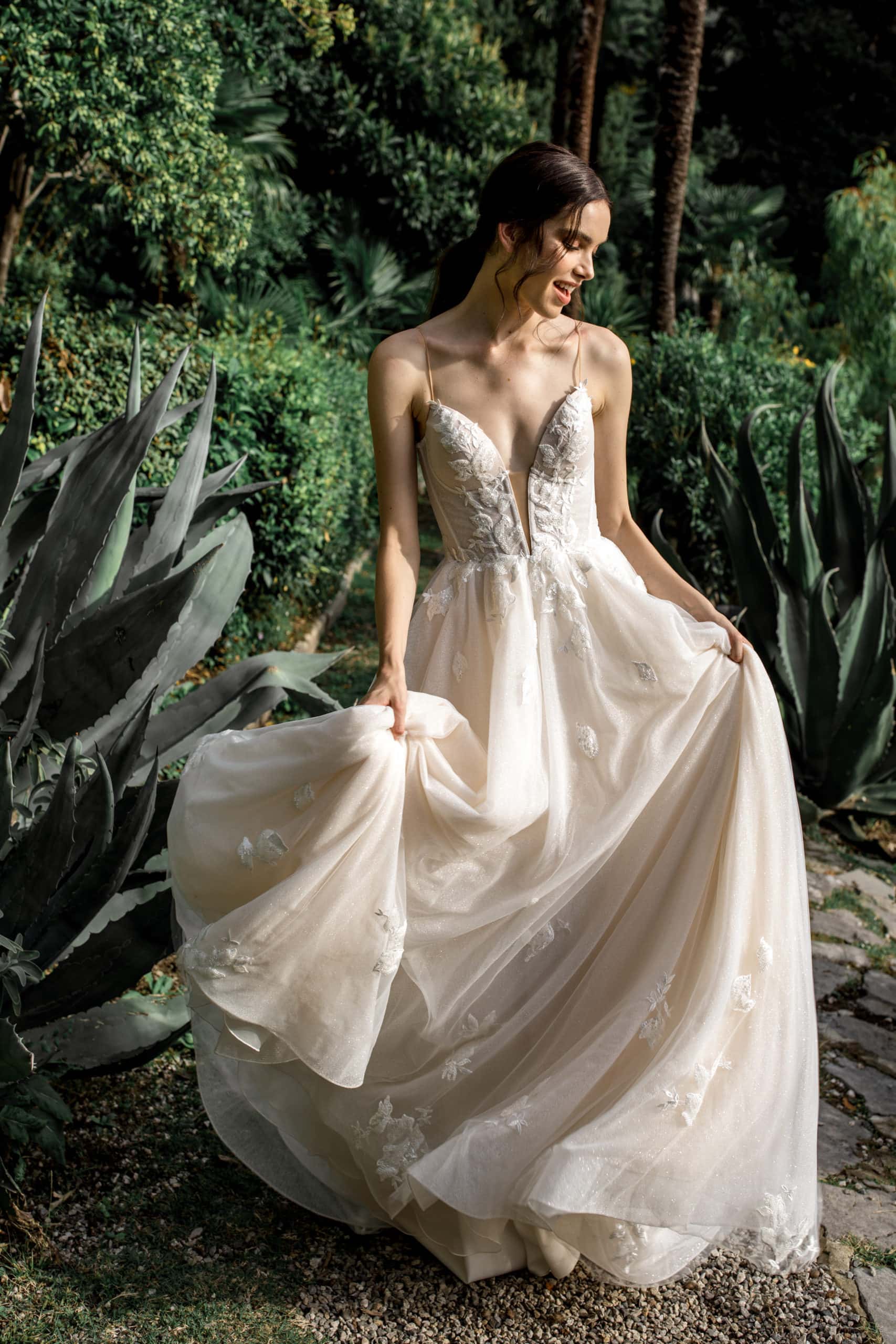 Model twirls in Ari Villoso bridal gown