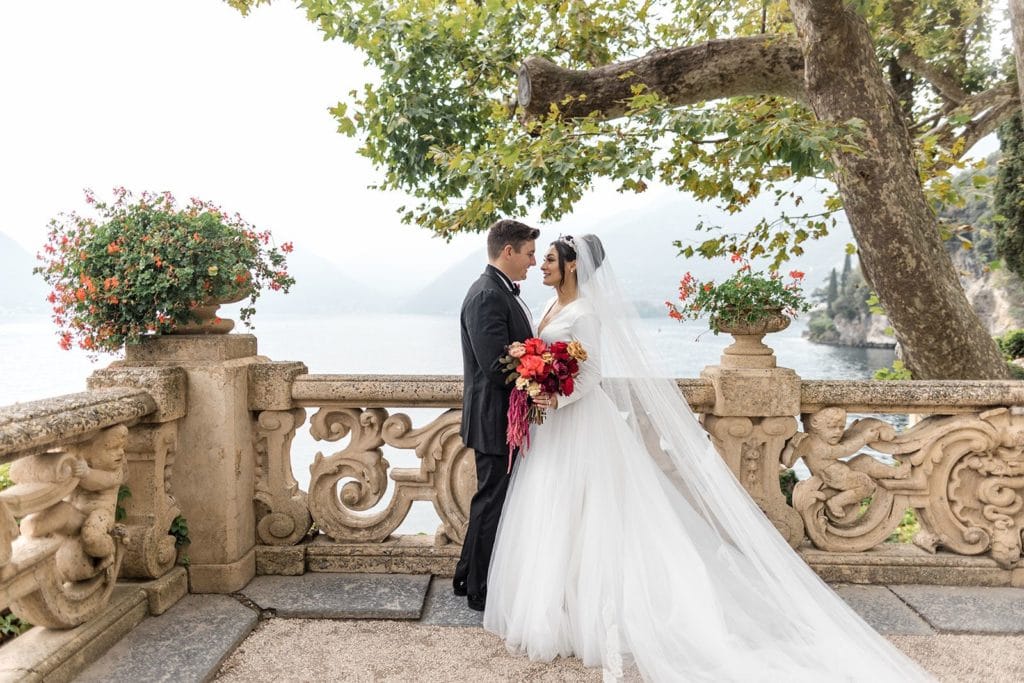Bride and groom embrace during couple's portraits at Villa del Balbianello wedding venue in Lake Como