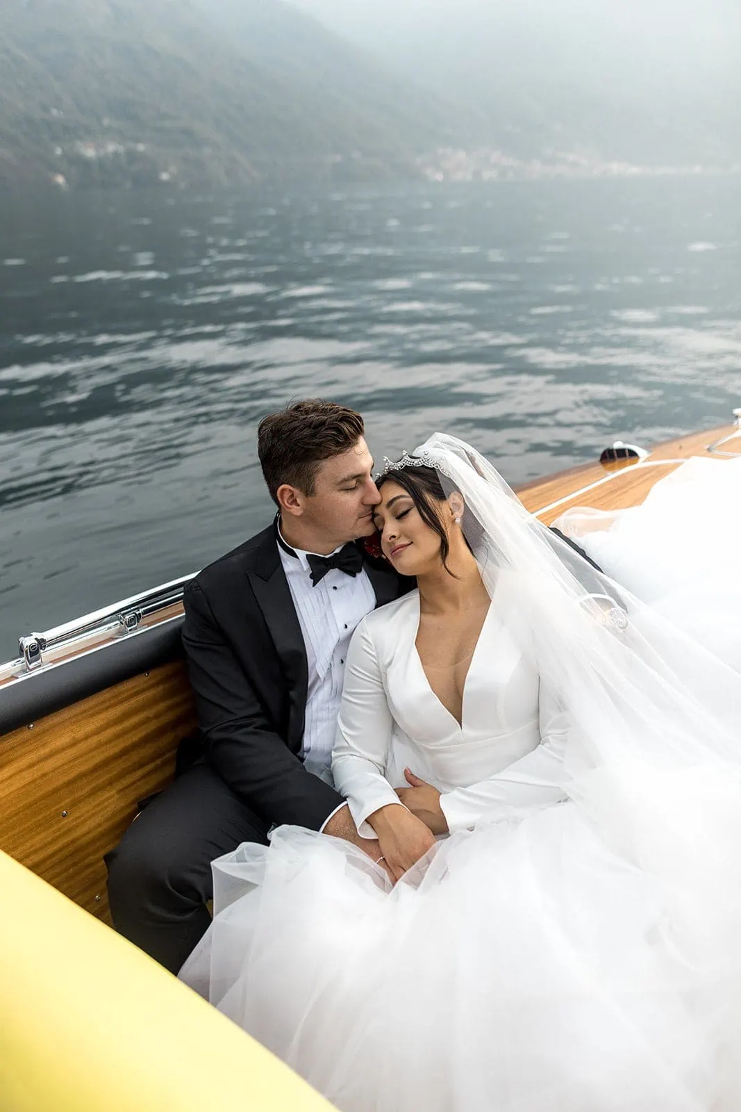 Bride and groom hug during Lake Como boat ride