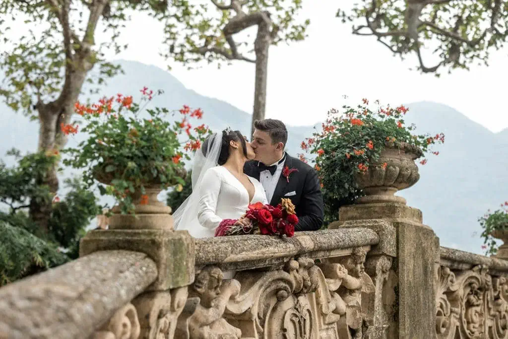 Bride and groom kiss at wedding venue in Lake Como