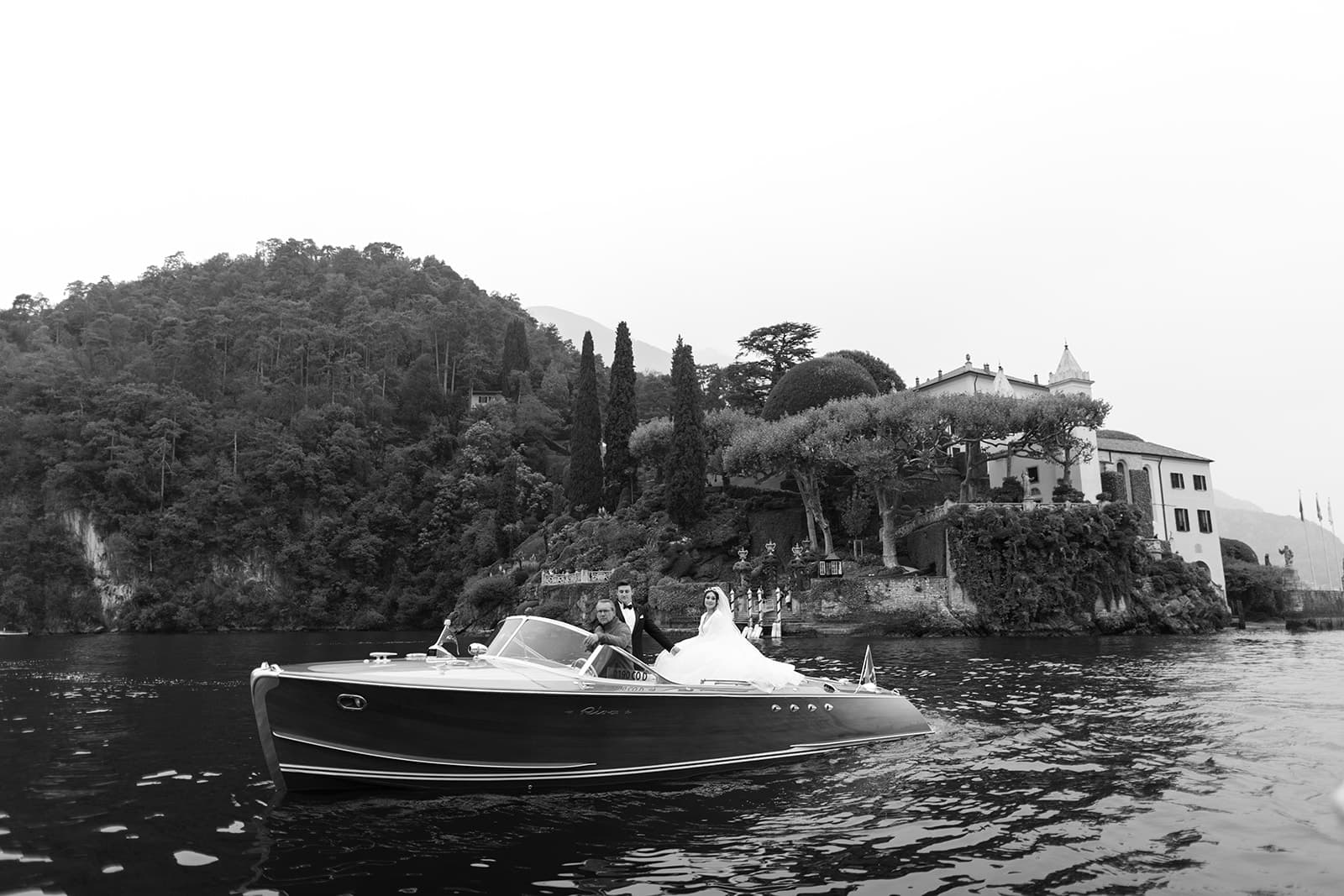 Bride and groom take classic Italian boat ride across Lake Como