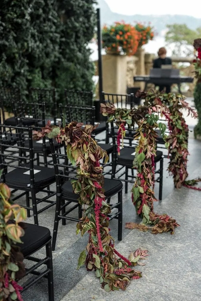 Floral swags as aisle markers for wedding ceremony chairs