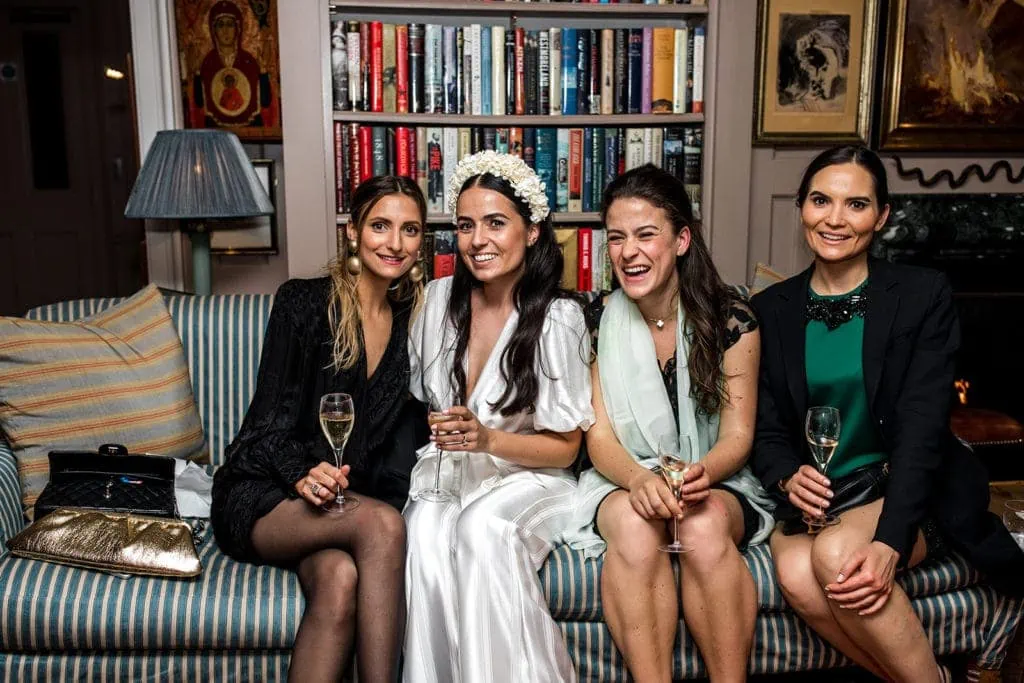 Bridal party lounges on sofa during cocktail hour at 5 Hertford Club in London