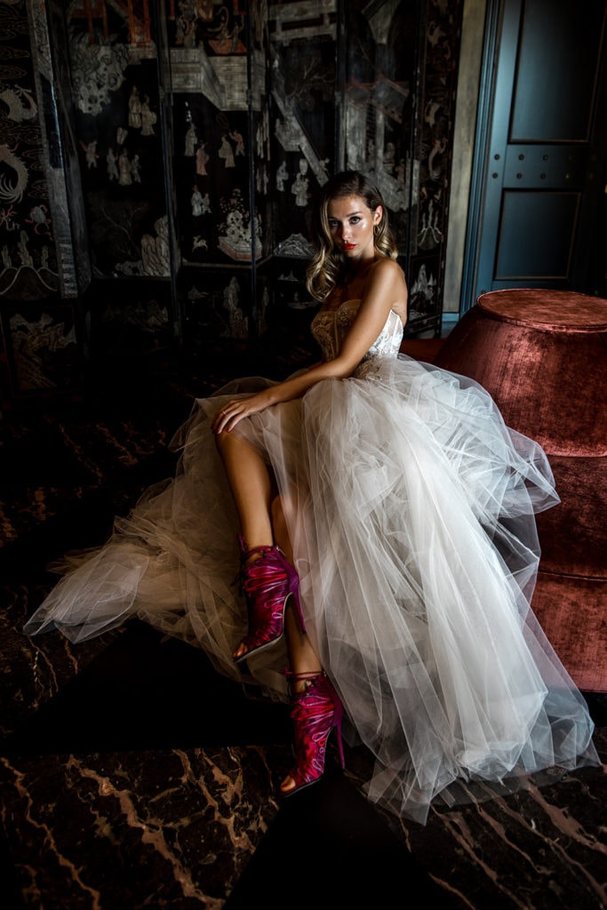 A model bride showcases her Berta wedding dress and merlot colored heels at a Rome wedding editorial session