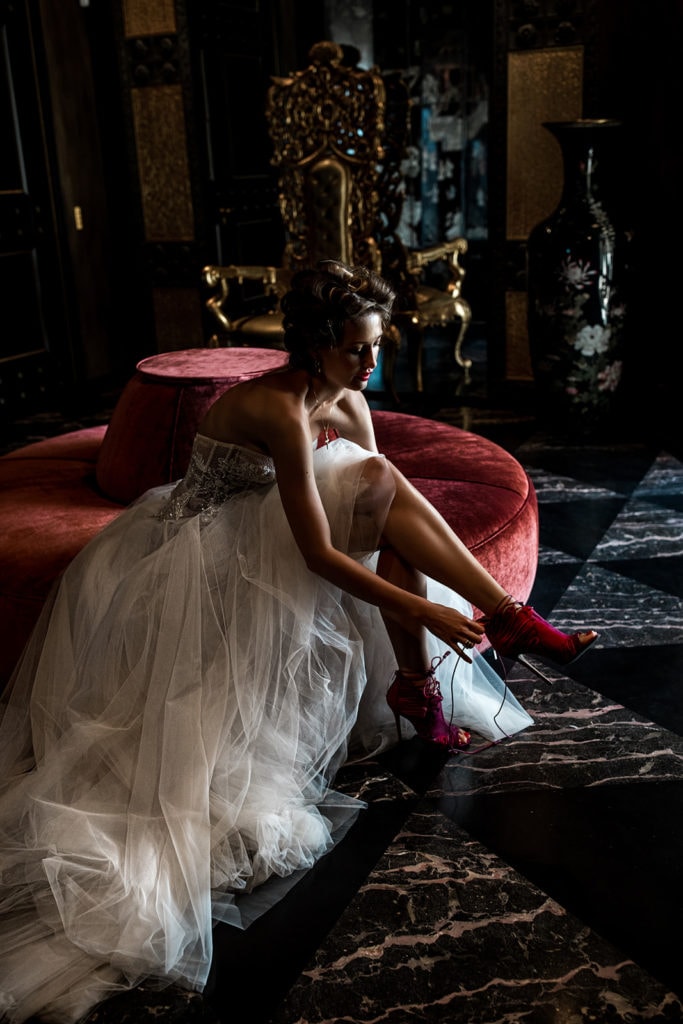 Bride wearing a Berta bridal gown puts on her heels for a Rome wedding
