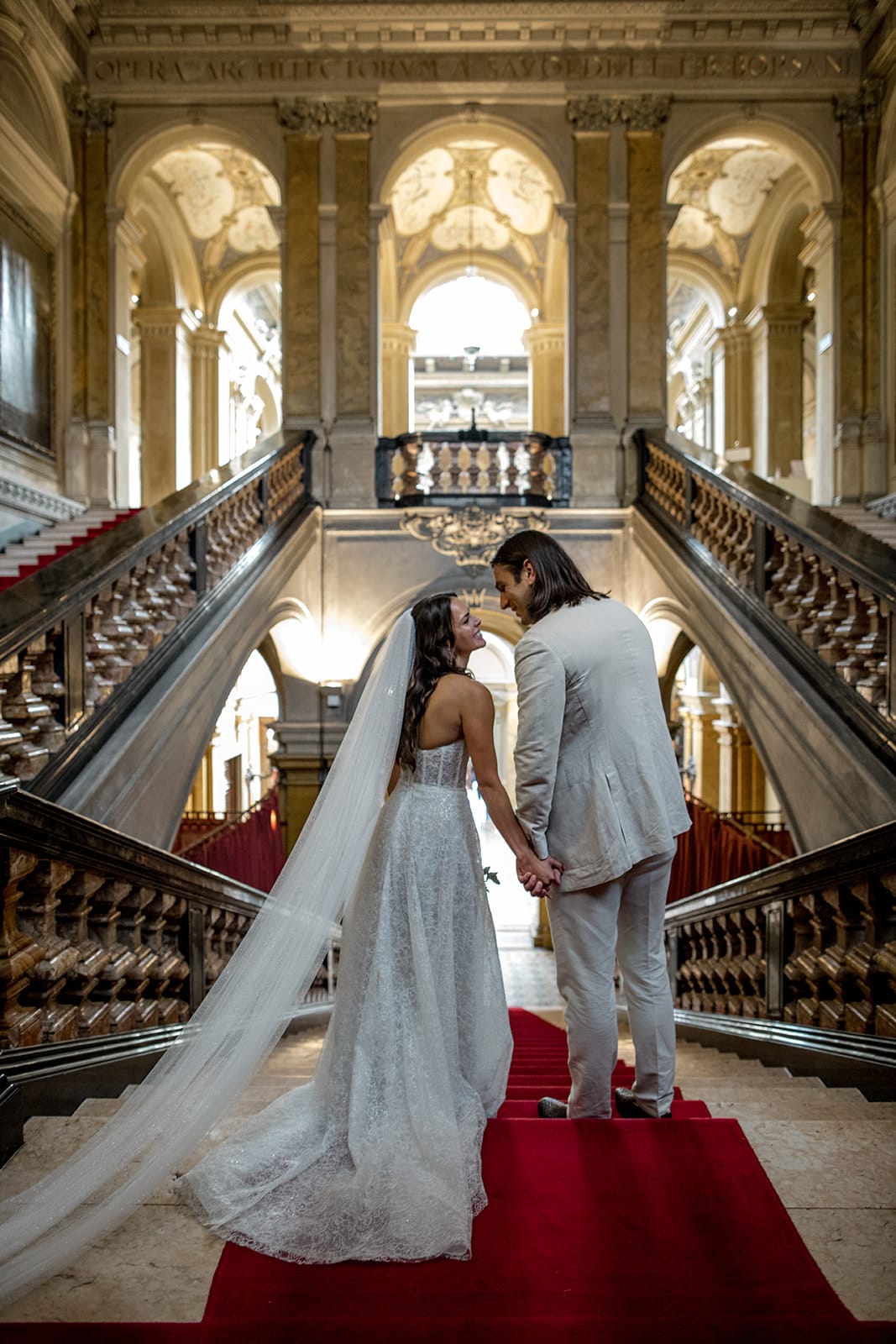 Bride and groom stand at top of grand staircase at Villa Erba wedding