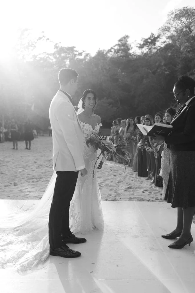 Bride and groom stand before officiant to recite vows at a wedding ceremony