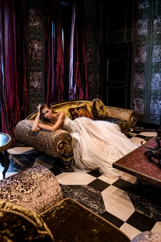 A model bride lounges on a sofa during a Rome wedding editorial session