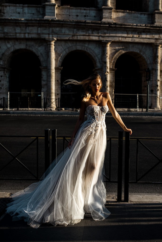 A model bride wearing a Berta wedding dress stands in front of the Roman Coliseum
