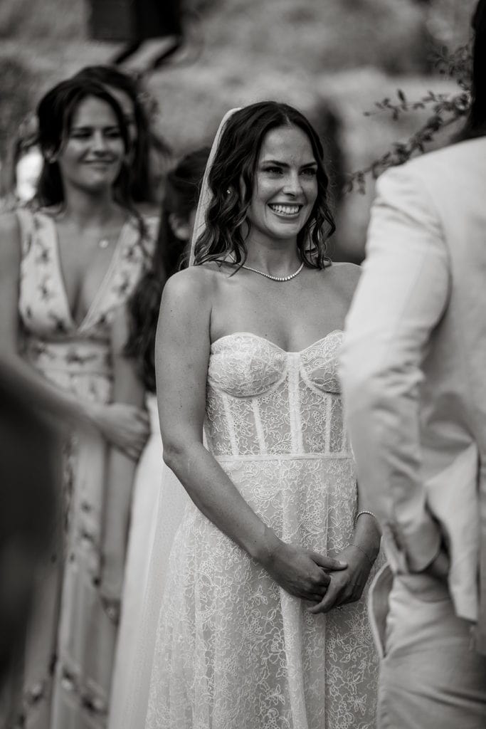 Bride smiles at groom during Lake Como wedding ceremony
