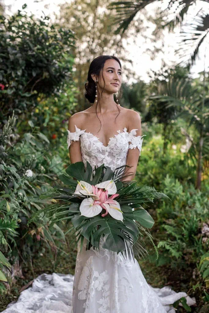 A bride holds her tropical bridal bouquet in the Jamaican rainforest