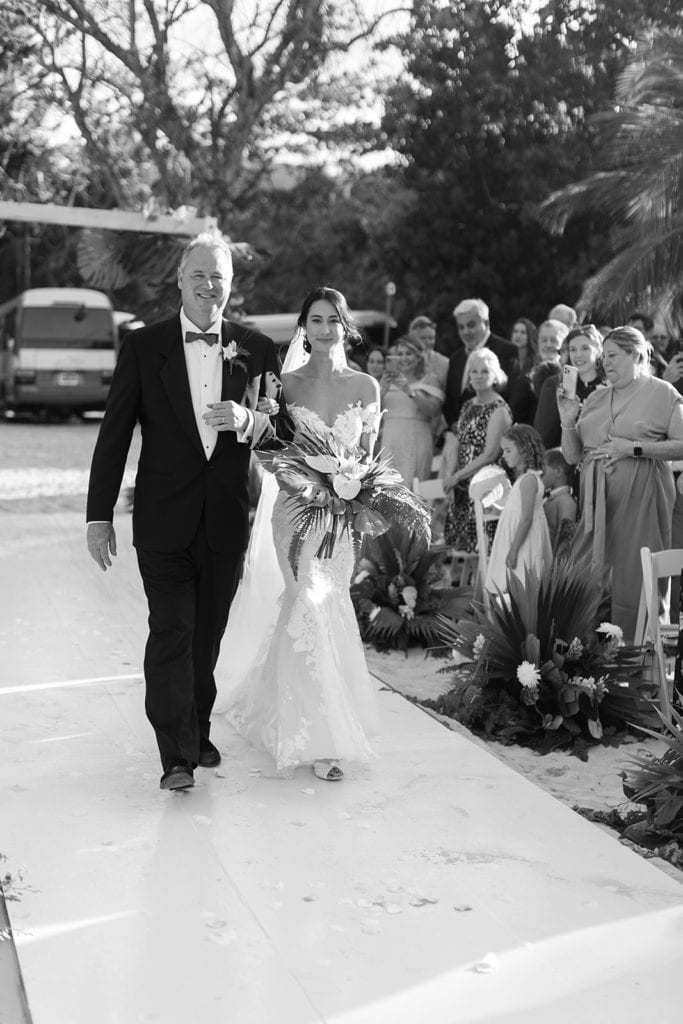 Father and bride walk down the aisle for a Jamaican beach wedding