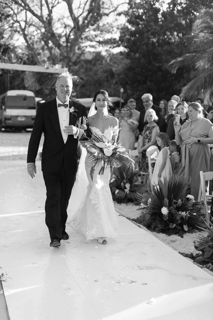 Father and bride walk down the aisle for a Jamaican beach wedding