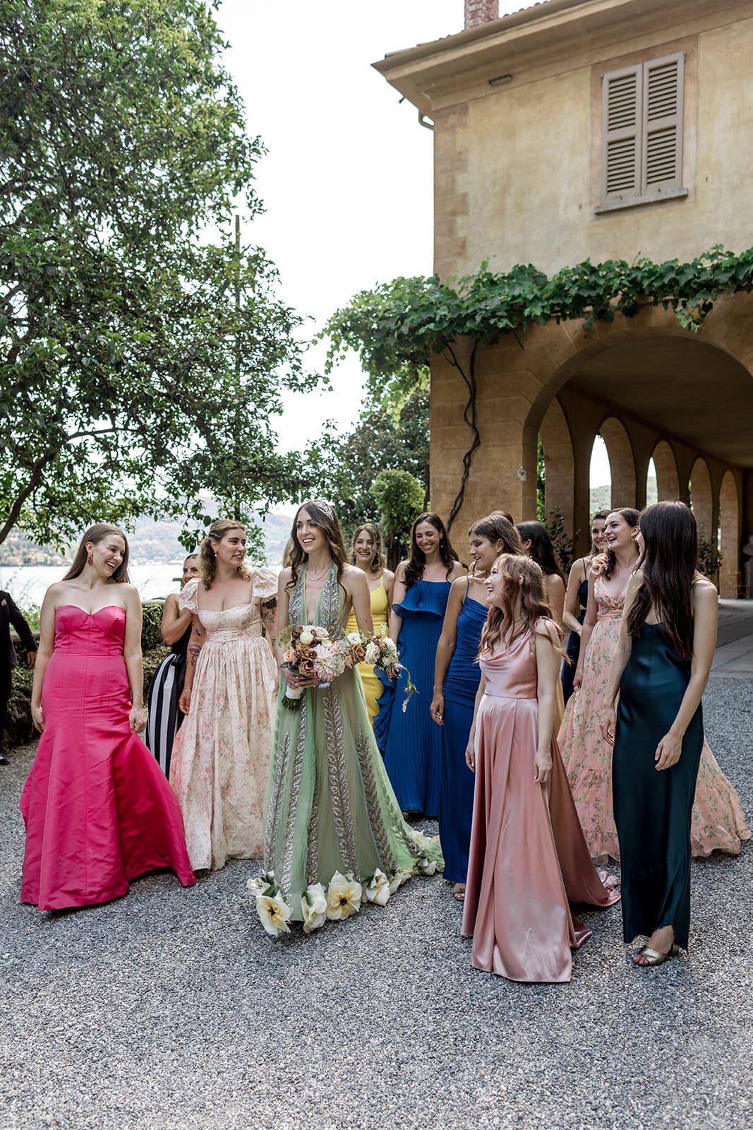 Bride and bridal party walk outside of Villa Pizzo in Italy