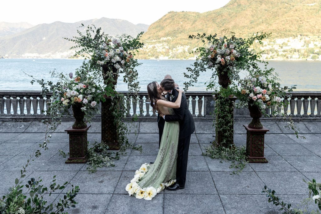 Bride and groom kiss at there ceremony site during a Villa Pizzo wedding