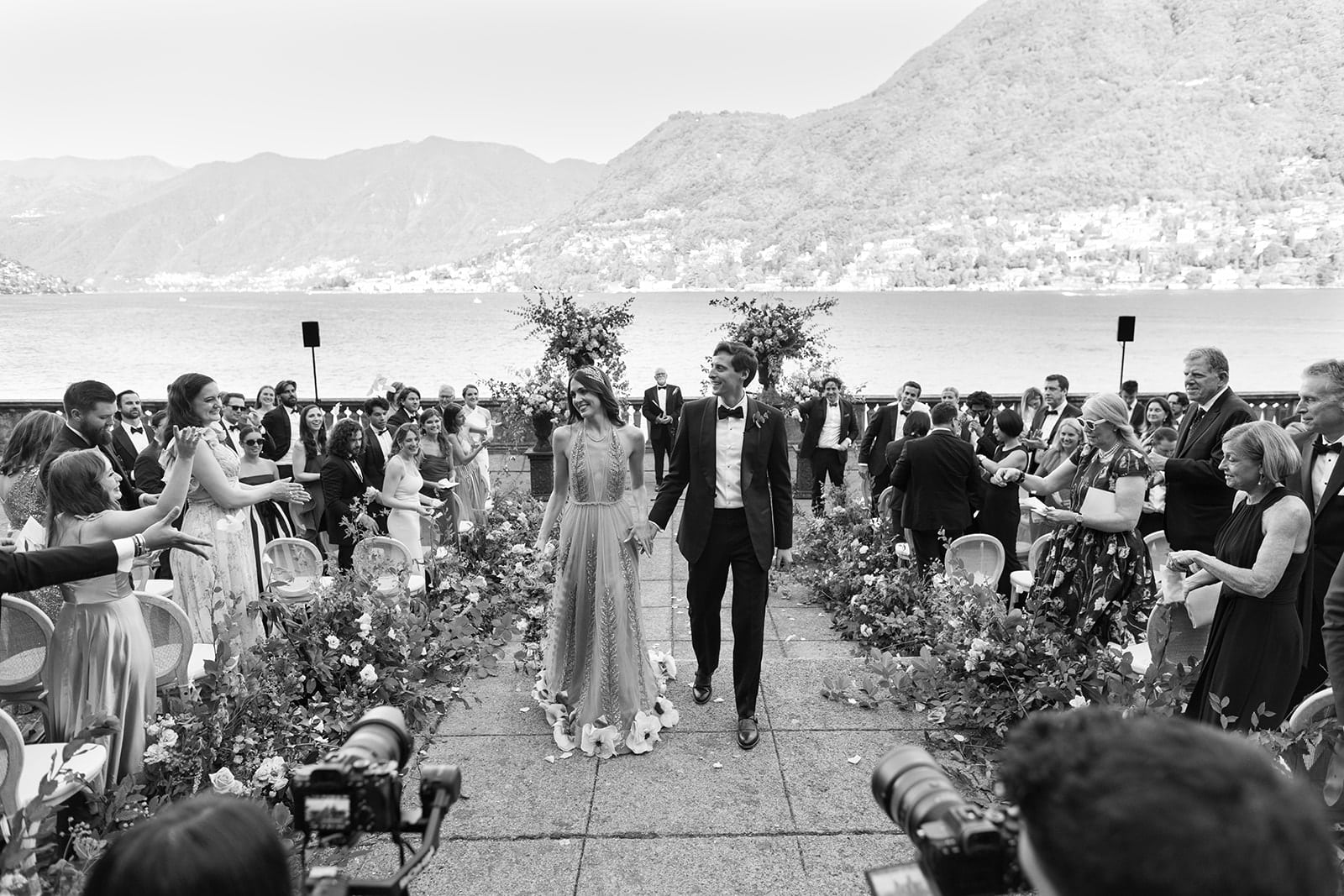 Bride and groom walk down the ceremony aisle at a Lake Como wedding villa