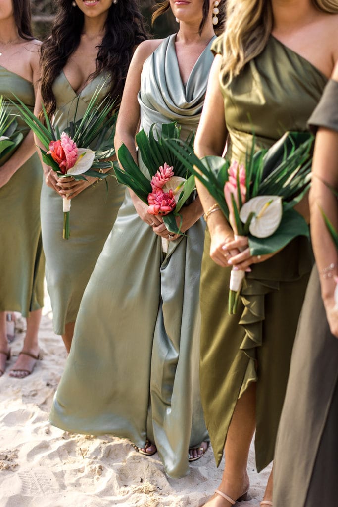 Tropical bridesmaids bouquets match shades of green dresses
